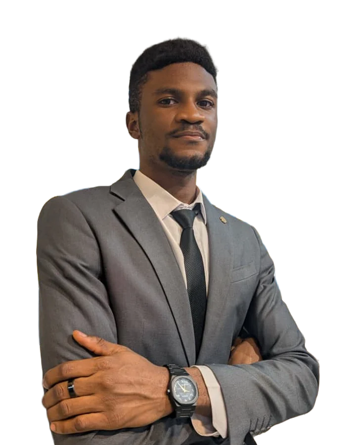 Makinde David Craig, founder and CEO of MDC Studios, in a grey suit with arms crossed